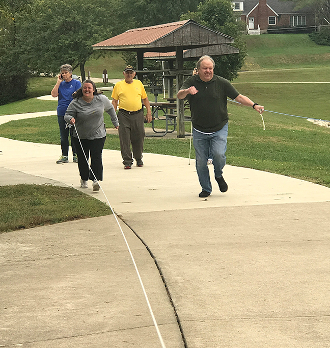 Melissa Smith and Gary Wunder race along a rope.